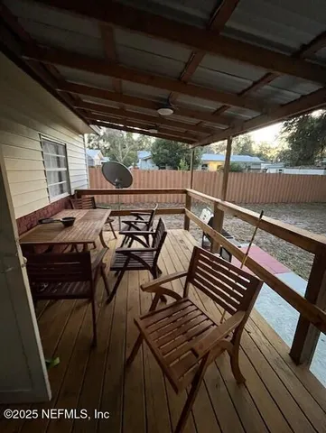 a view of a patio with table and chairs