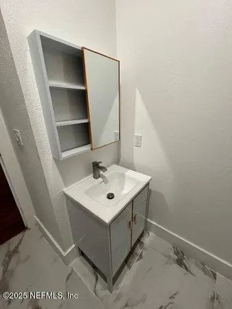 a bathroom with a sink a mirror and vanity