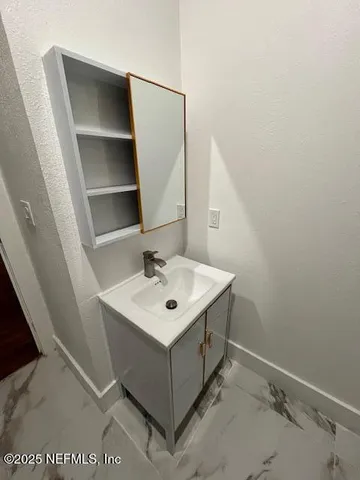 a bathroom with a sink a mirror and vanity