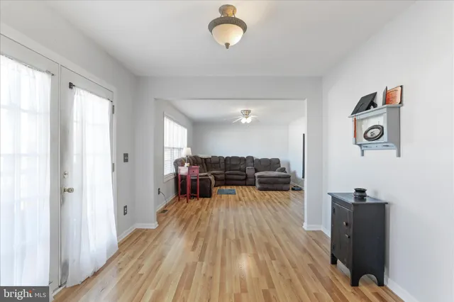a view of a workspace with furniture and wooden floor
