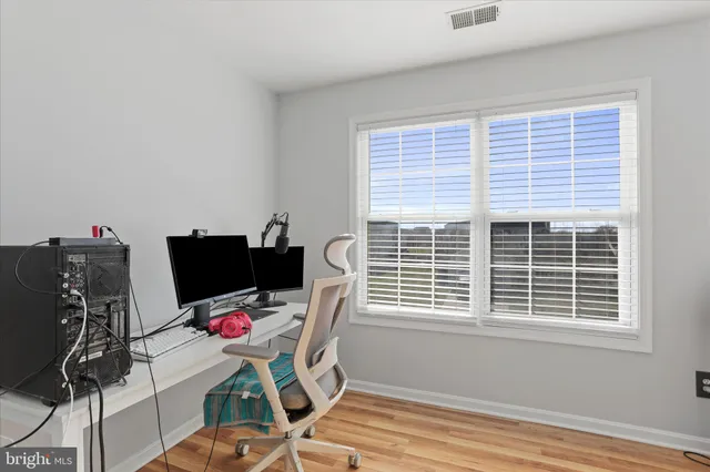 a view of a workspace with furniture and a window