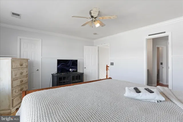 a bedroom with a bed and a television