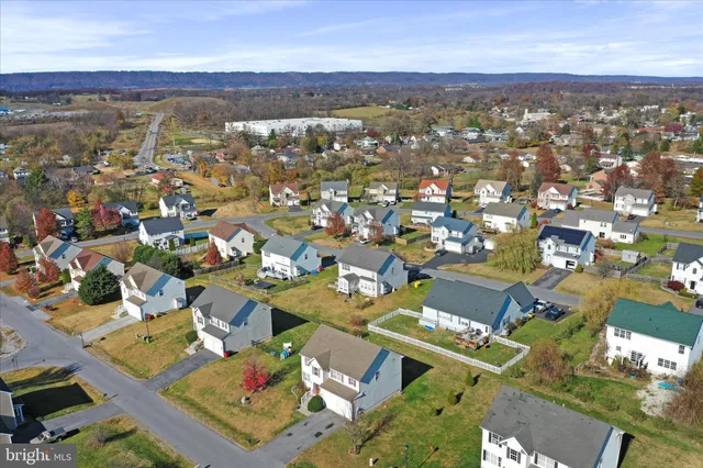 an aerial view of residential building with parking