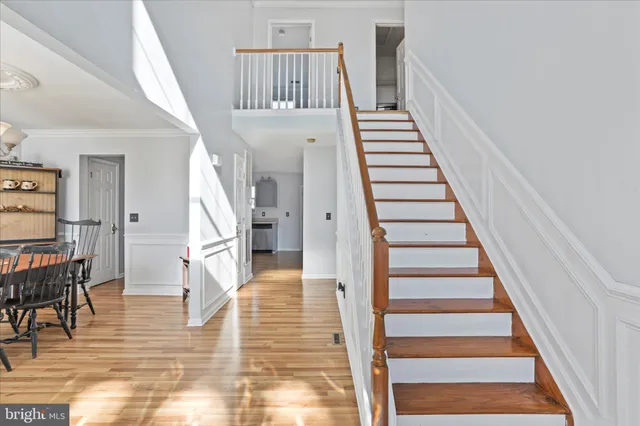 a view of entryway and hall with wooden floor