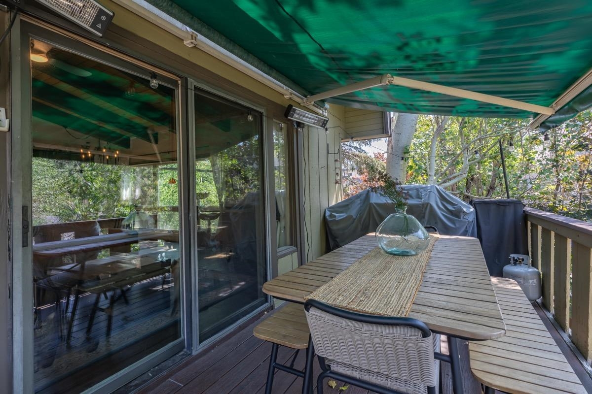 3251 Chateau Road, Unit 12 Mammoth Lakes, CA 93546 - Photo 31 of 50 a view of a patio with a table chairs and a backyard
