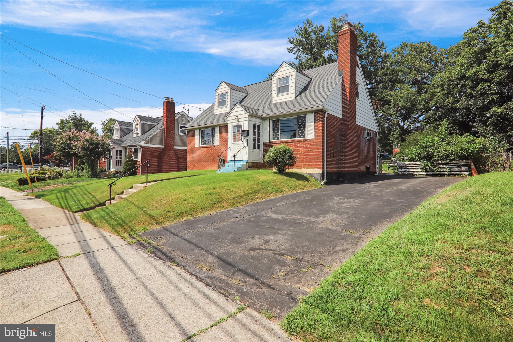 9507 Adelphi Road Silver Spring, MD 20903 - Photo 2 of 41 a view of a big house with a big yard and large trees