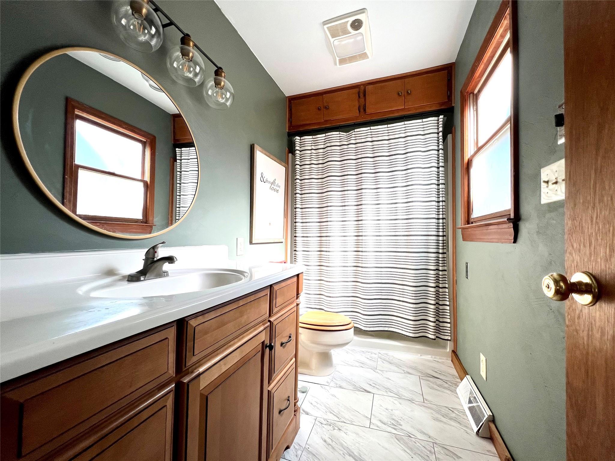 3430 Rimer Road Concord, NC 28025 - Photo 17 of 32 a bathroom with a sink a toilet and a mirror