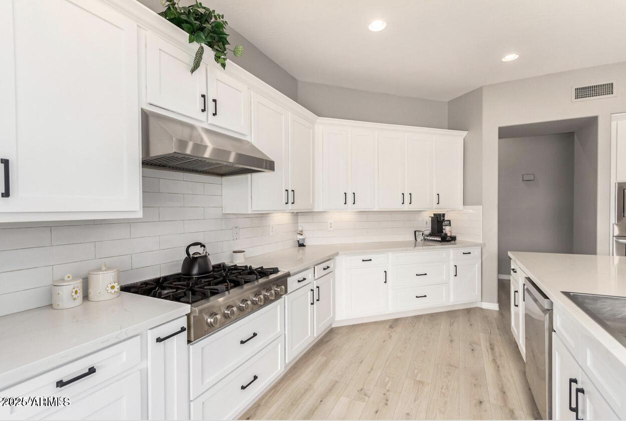 1515 North Los Alamos Circle Mesa, AZ 85213 - Photo 12 of 39 a kitchen with stainless steel appliances a sink a stove and cabinets