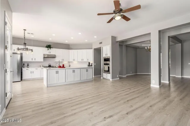 a view of kitchen with wooden floor and electronic appliances