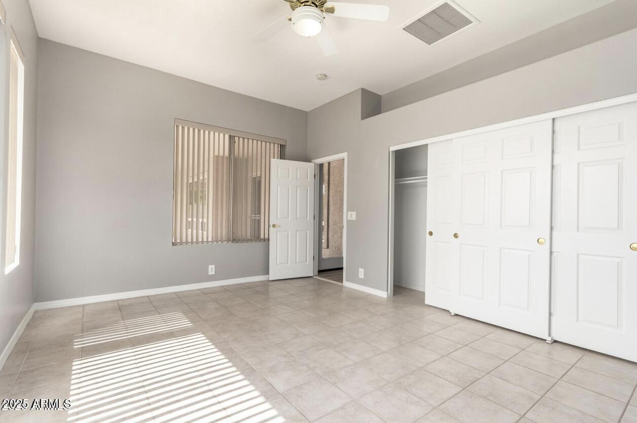 1515 North Los Alamos Circle Mesa, AZ 85213 - Photo 26 of 39 a view of an empty room with window and chandelier fan