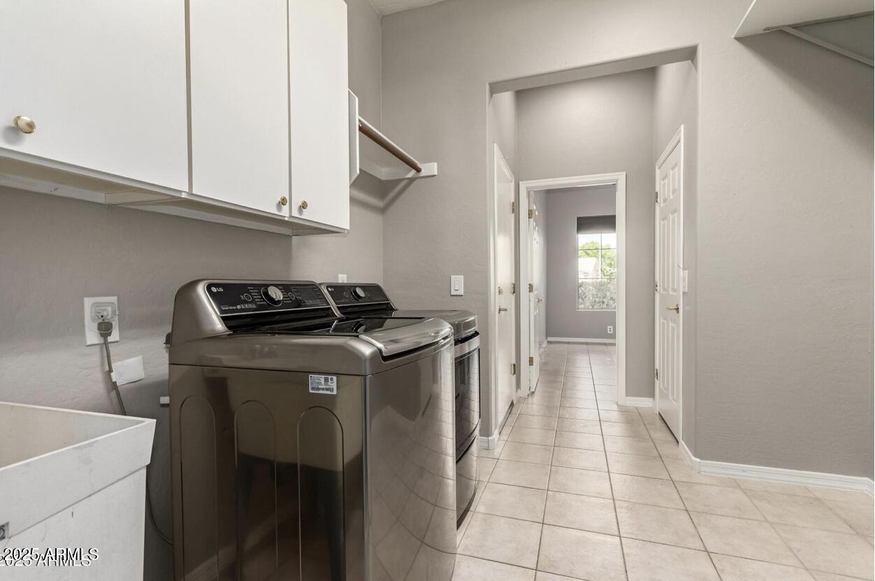 1515 North Los Alamos Circle Mesa, AZ 85213 - Photo 32 of 39 a view of a kitchen with washing machine and cabinets