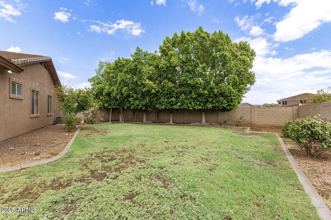 1515 North Los Alamos Circle Mesa, AZ 85213 - Photo 34 of 39 a backyard of a house with lots of green space