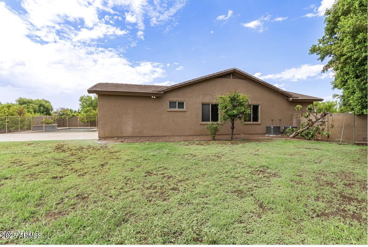1515 North Los Alamos Circle Mesa, AZ 85213 - Photo 35 of 39 a backyard of a house with plants and tree