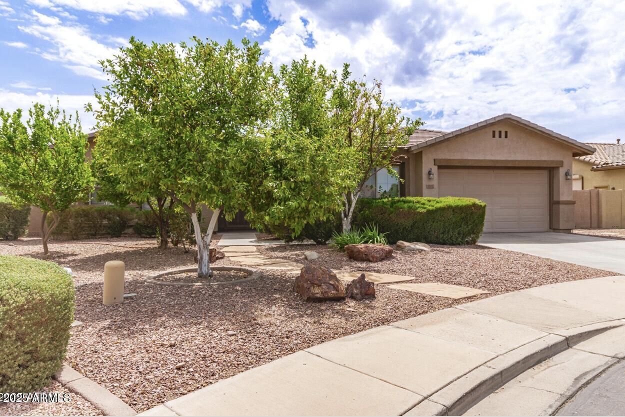 1515 North Los Alamos Circle Mesa, AZ 85213 - Photo 36 of 39 a front view of a house with a yard and garage