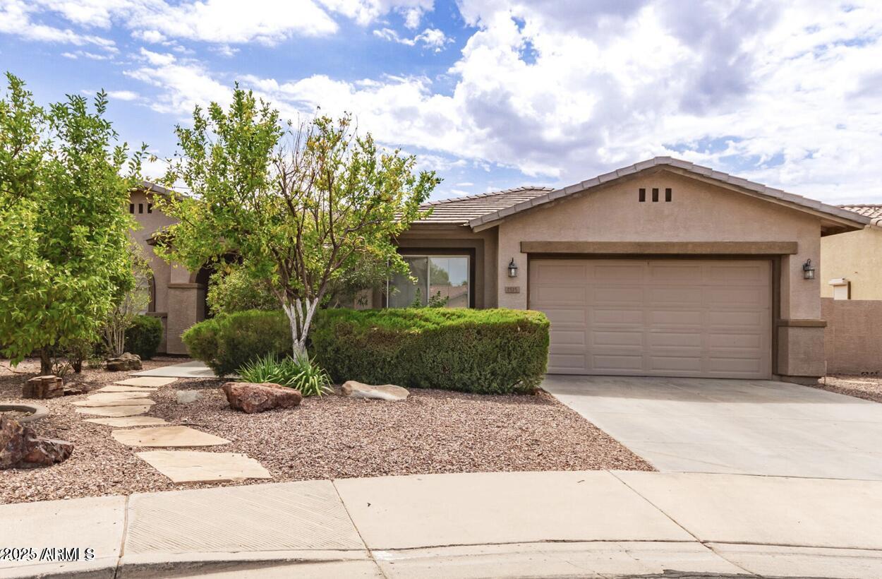 1515 North Los Alamos Circle Mesa, AZ 85213 - Photo 38 of 39 a front view of a house with a yard and garage
