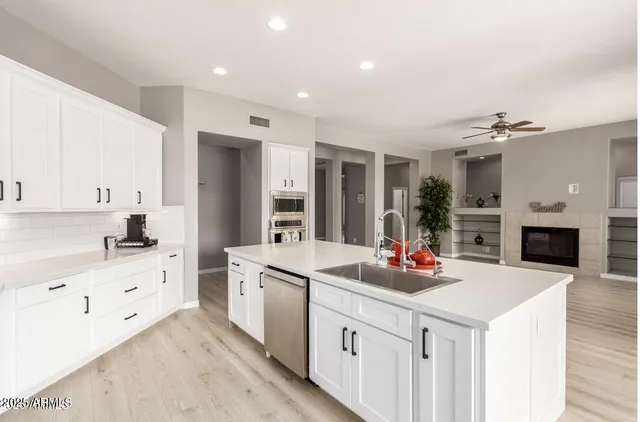 a kitchen with stainless steel appliances a sink stove and cabinets