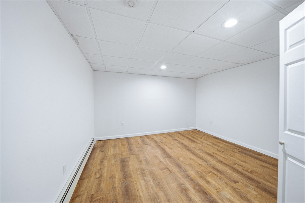 39 Hawthorne Street, Unit 39 Boston, MA 02119 - Photo 25 of 33 a view of empty room with wooden floor
