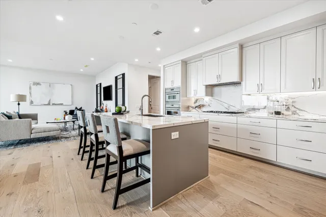 a living room with furniture a fireplace and a chandelier