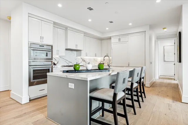 a dining room with furniture a chandelier and wooden floor