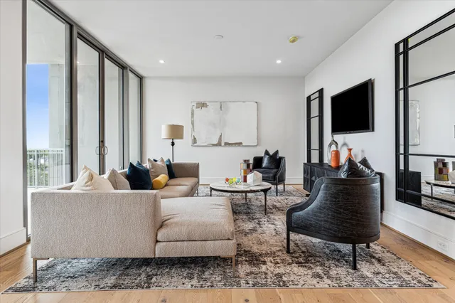 a bedroom with a bed and a large window