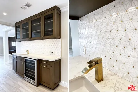 an empty room with wooden floor and fireplace