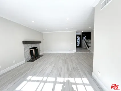 a kitchen with granite countertop wooden cabinets and center island