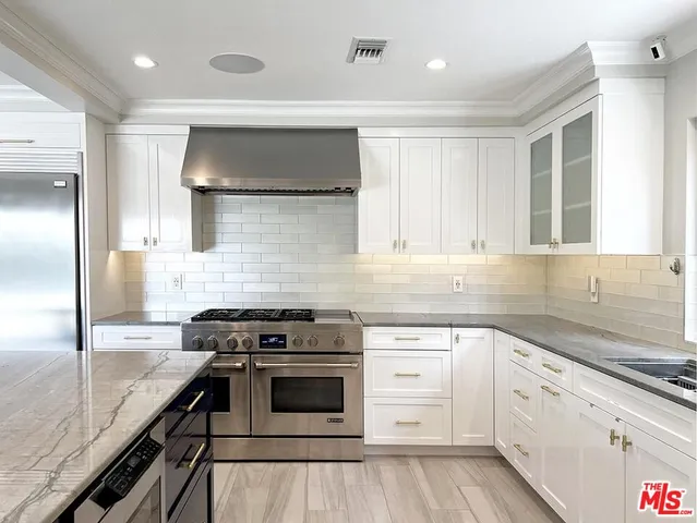 a view of a livingroom with wooden floor and stairs