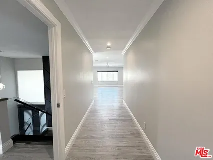 a view of a kitchen cabinets a sink and wooden floor