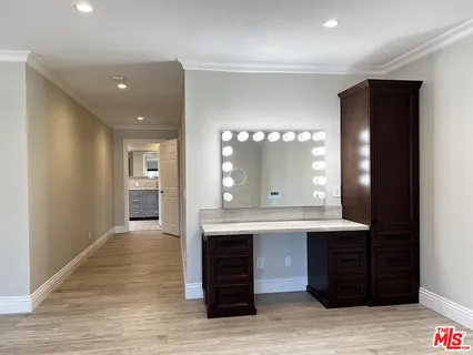 a bathroom with a tub sink mirror and shower