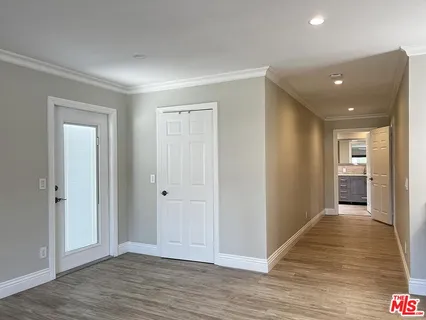 a view of a hallway with wooden floor