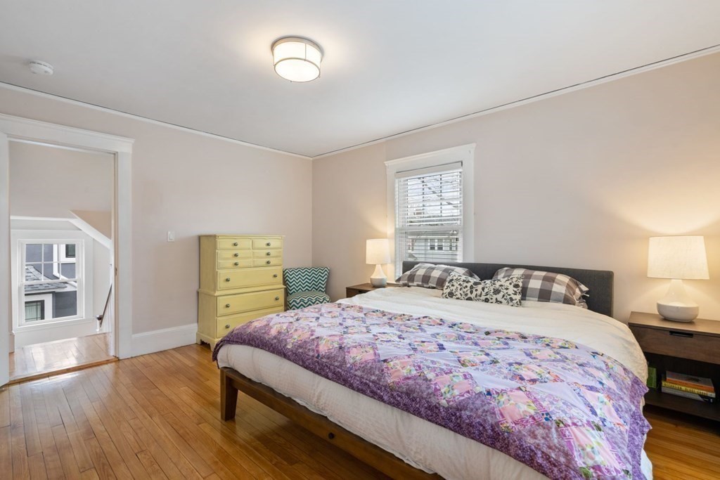 38 Jackson Road Medford, MA 02155 - Photo 21 of 42 a bedroom with a bed and wooden floor