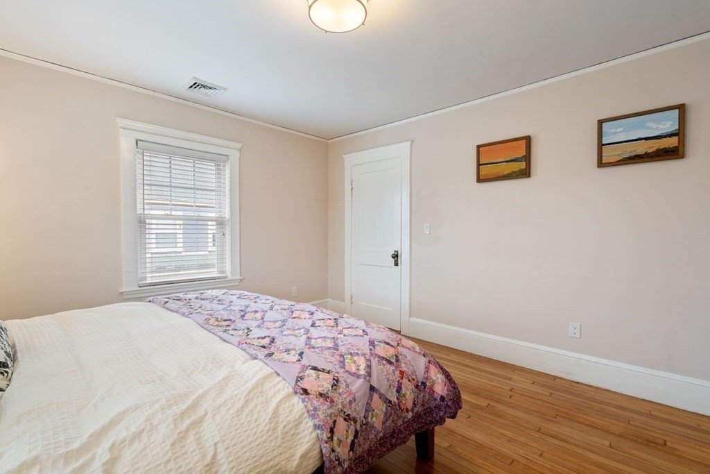 38 Jackson Road Medford, MA 02155 - Photo 22 of 42 a bedroom with a bed and wooden floor
