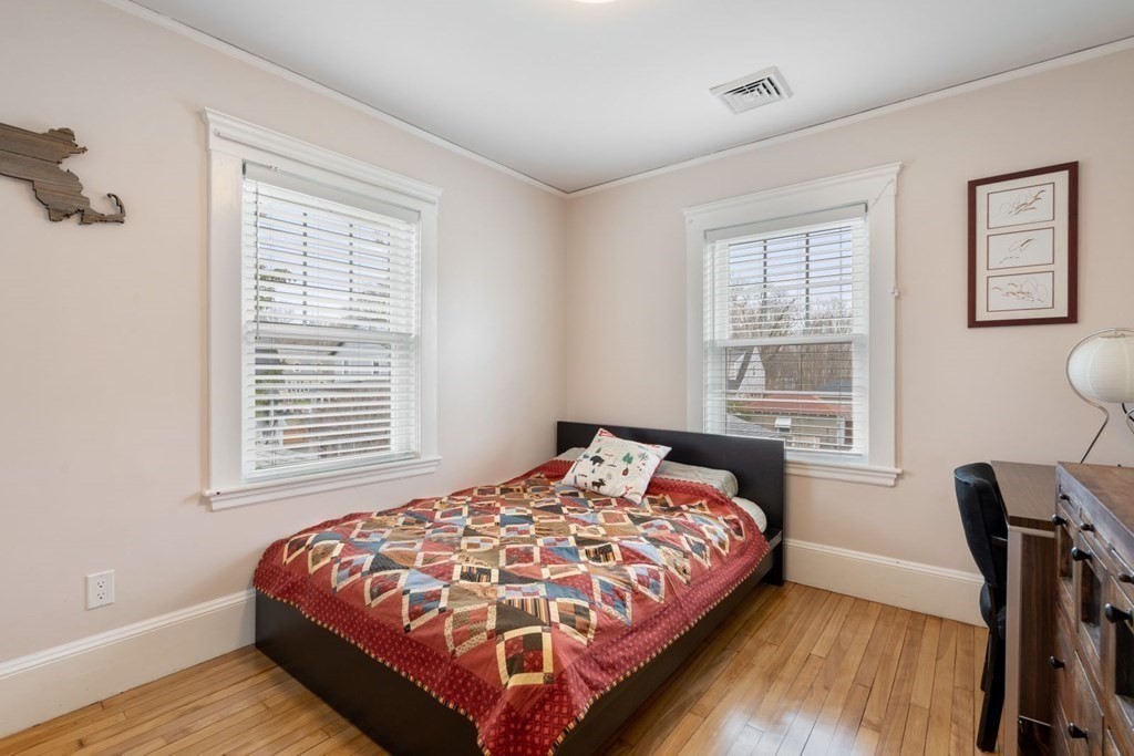 38 Jackson Road Medford, MA 02155 - Photo 23 of 42 a bedroom with a bed a dresser and a large window
