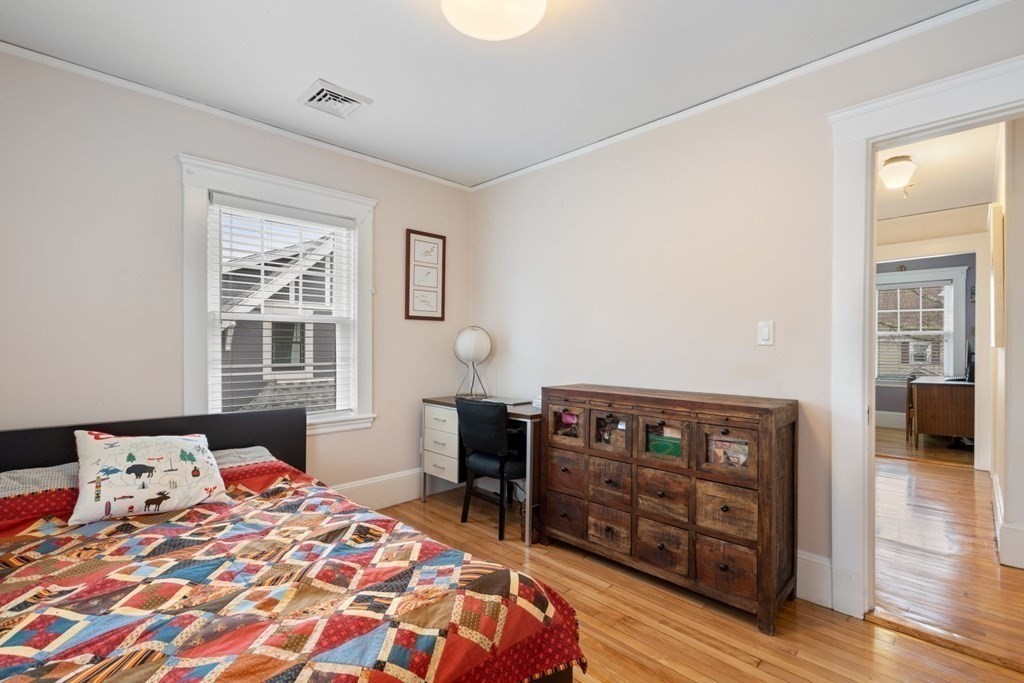 38 Jackson Road Medford, MA 02155 - Photo 24 of 42 a bedroom with a bed and wooden floor