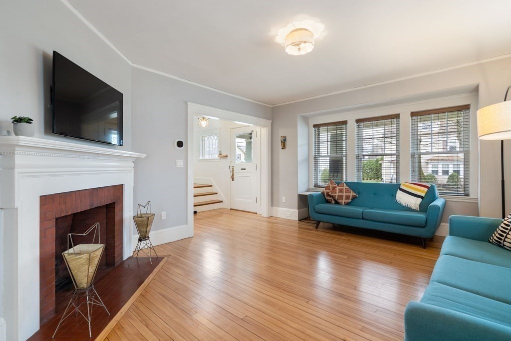 38 Jackson Road Medford, MA 02155 - Photo 4 of 42 a living room with furniture and a fireplace