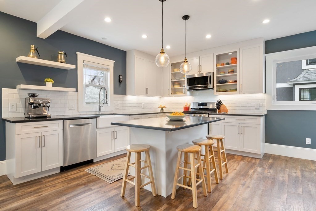 38 Jackson Road Medford, MA 02155 - Photo 9 of 42 a kitchen with stainless steel appliances granite countertop a stove a sink and a refrigerator