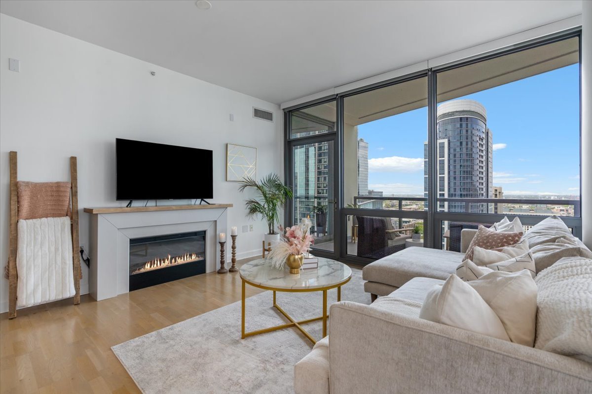 1235 South Prairie Avenue, Unit 2709 Chicago, IL 60605 - Photo 11 of 46 a living room with furniture a fireplace and a flat screen tv