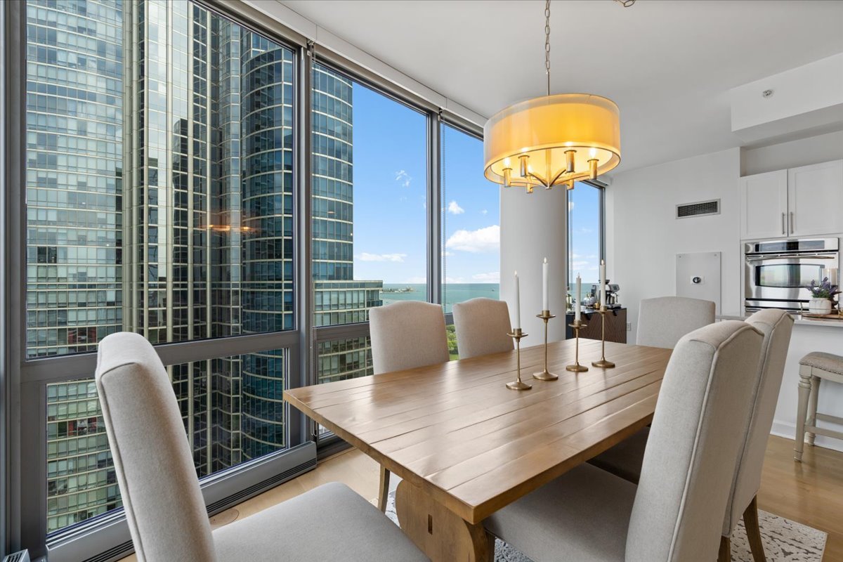 1235 South Prairie Avenue, Unit 2709 Chicago, IL 60605 - Photo 15 of 46 a view of a dining room with furniture and chandelier