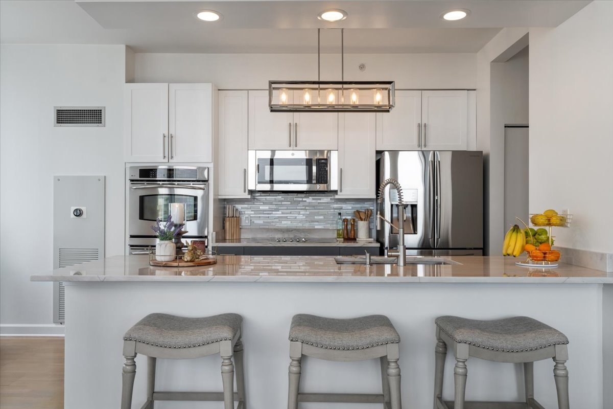 1235 South Prairie Avenue, Unit 2709 Chicago, IL 60605 - Photo 17 of 46 a kitchen with stainless steel appliances a sink and a refrigerator