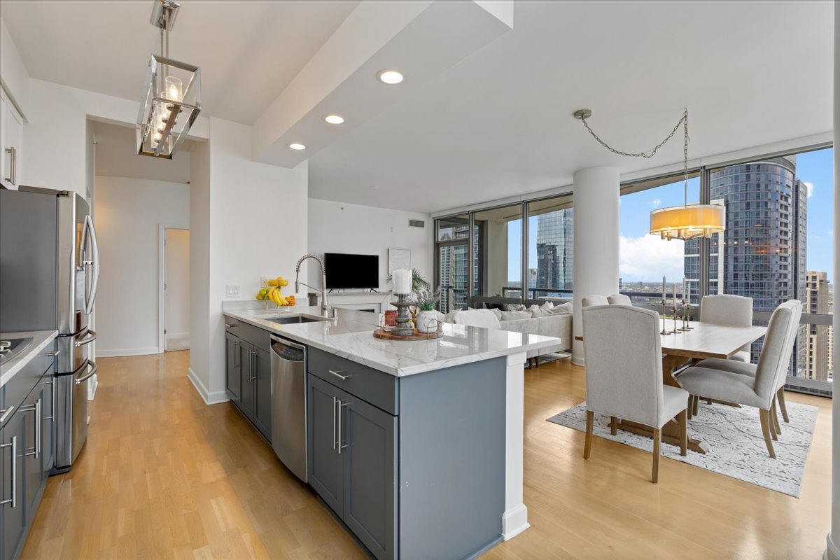 1235 South Prairie Avenue, Unit 2709 Chicago, IL 60605 - Photo 20 of 46 a large kitchen with a table and chairs