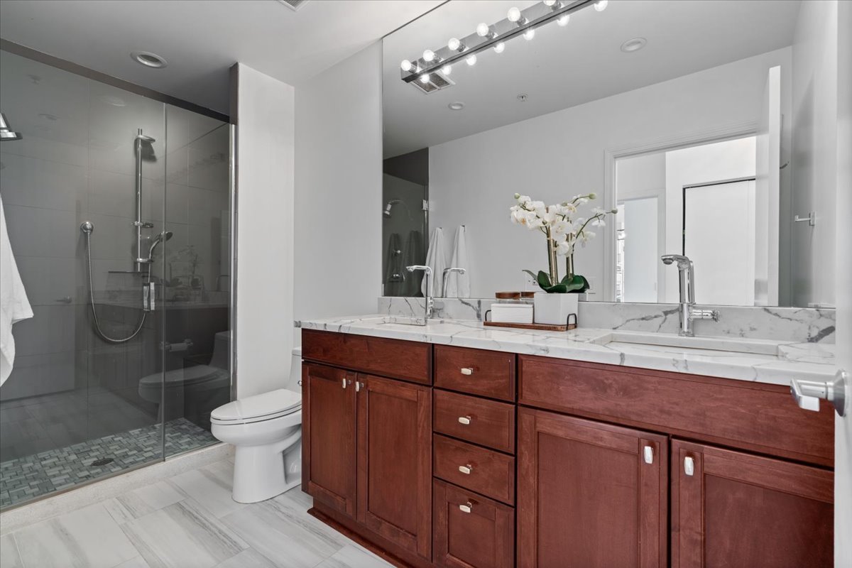 1235 South Prairie Avenue, Unit 2709 Chicago, IL 60605 - Photo 25 of 46 a spacious bathroom with a double vanity sink mirror double shower and a toilet