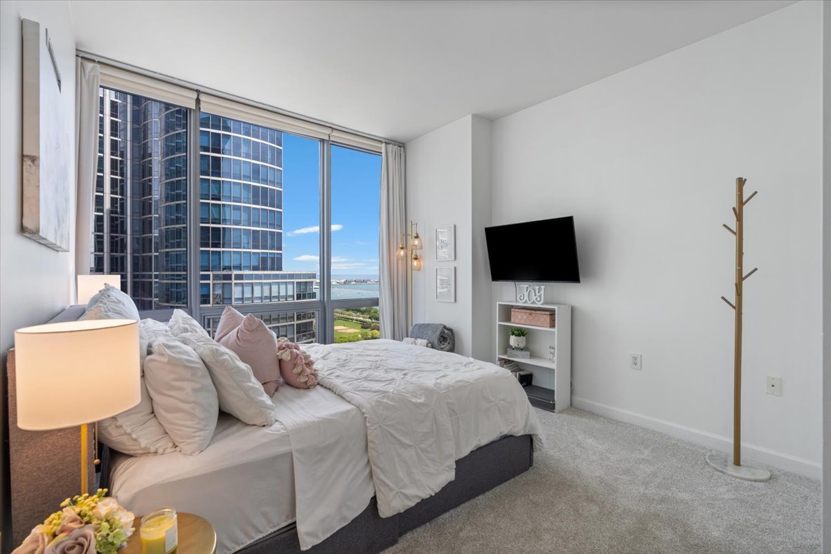 1235 South Prairie Avenue, Unit 2709 Chicago, IL 60605 - Photo 28 of 46 a bedroom with a bed and a flat screen tv