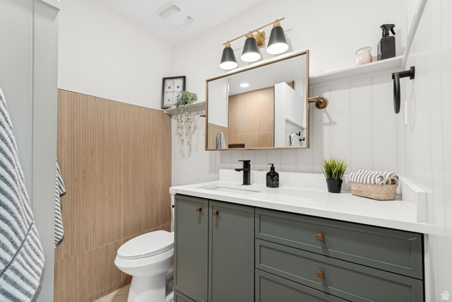 1010 West Maple Street Mapleton, UT 84664 - Photo 12 of 24 Bathroom featuring a white vanity with a quartz countertop, matte black faucet, and a rectangular gold-framed mirror