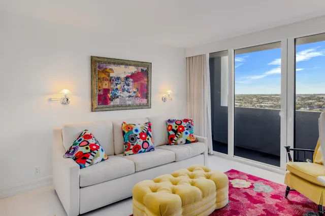 a living room with furniture and a floor to ceiling window