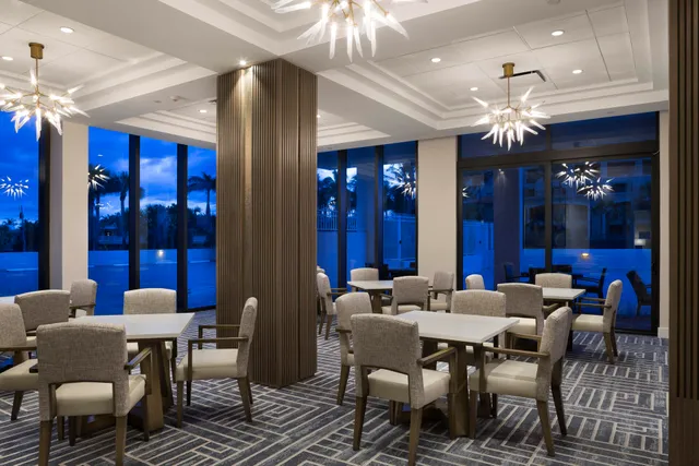 a view of a dining room with furniture chandelier and a chandelier