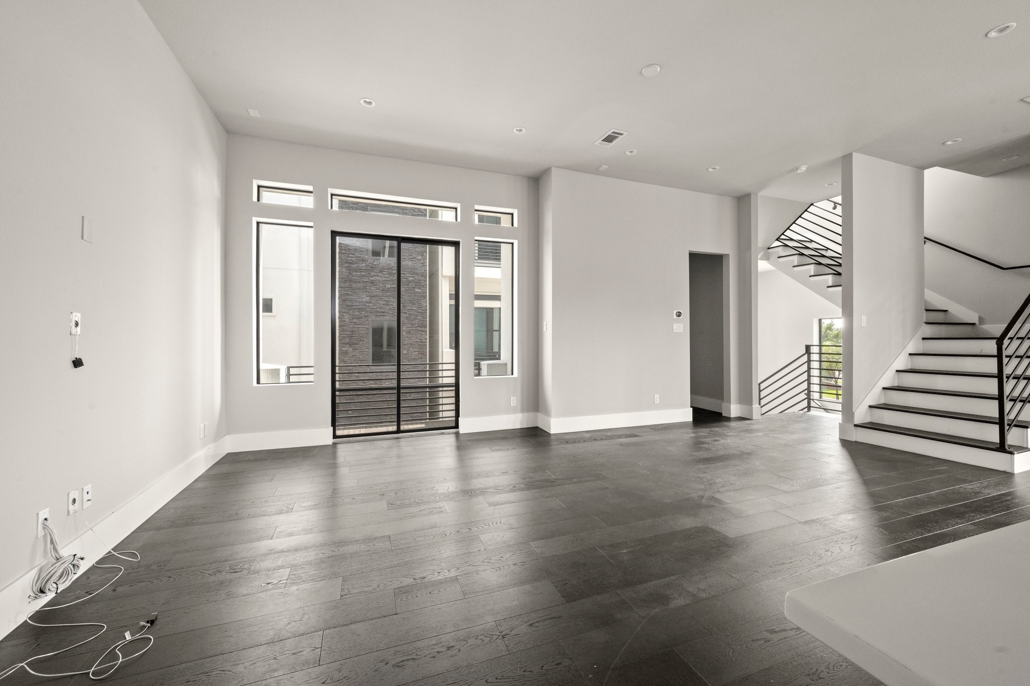 1615 Wheeler Avenue, Unit A Houston, TX 77004 - Photo 11 of 28 an empty room with wooden floor and windows