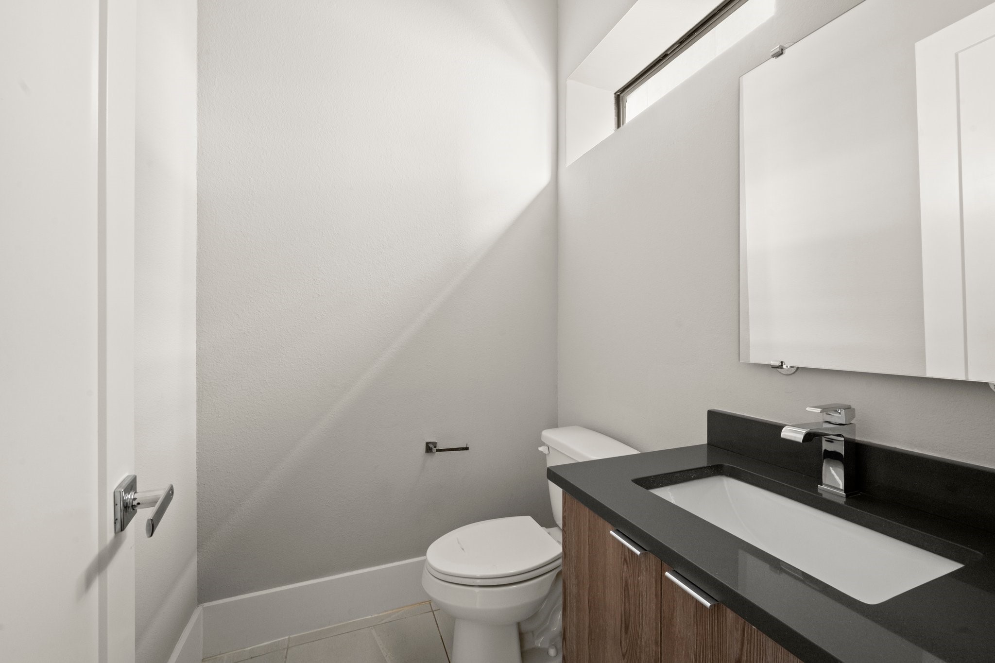 1615 Wheeler Avenue, Unit A Houston, TX 77004 - Photo 16 of 28 a bathroom with a granite countertop sink toilet and a mirror