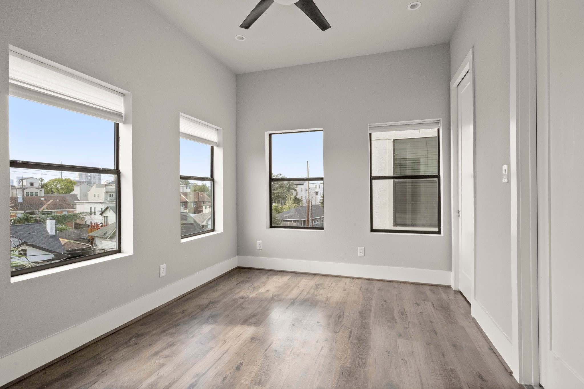 1615 Wheeler Avenue, Unit A Houston, TX 77004 - Photo 17 of 28 an empty room with wooden floor and windows