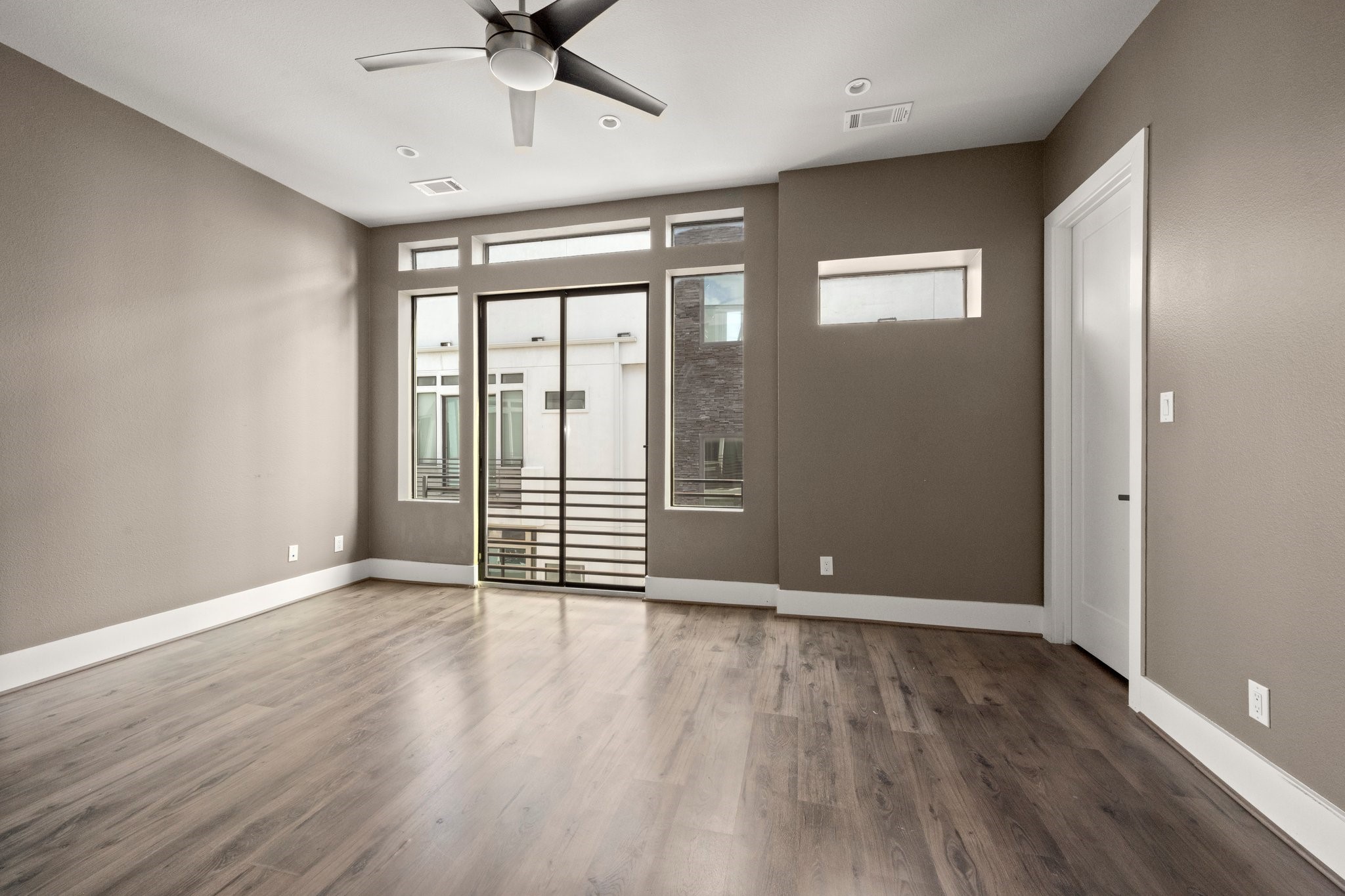 1615 Wheeler Avenue, Unit A Houston, TX 77004 - Photo 19 of 28 an empty room with wooden floor and windows