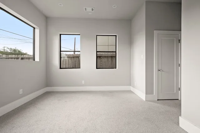 an empty room with windows and closet